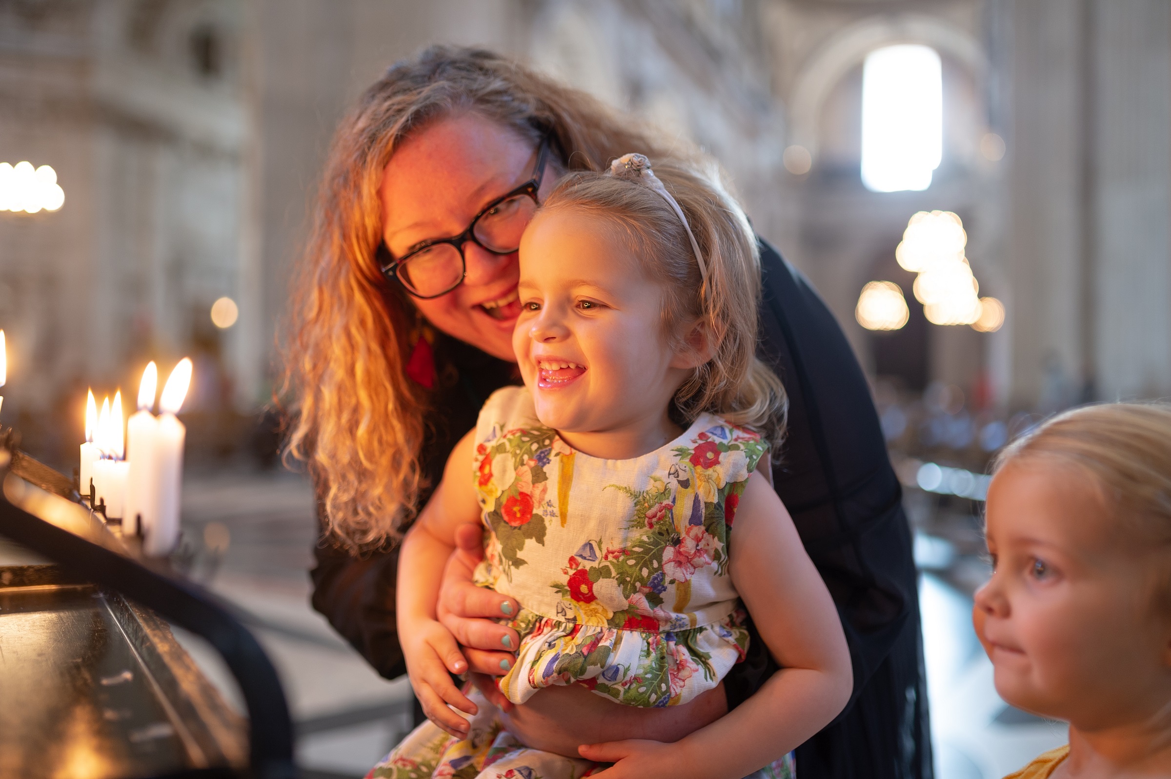 family children mother candles prayer smiling