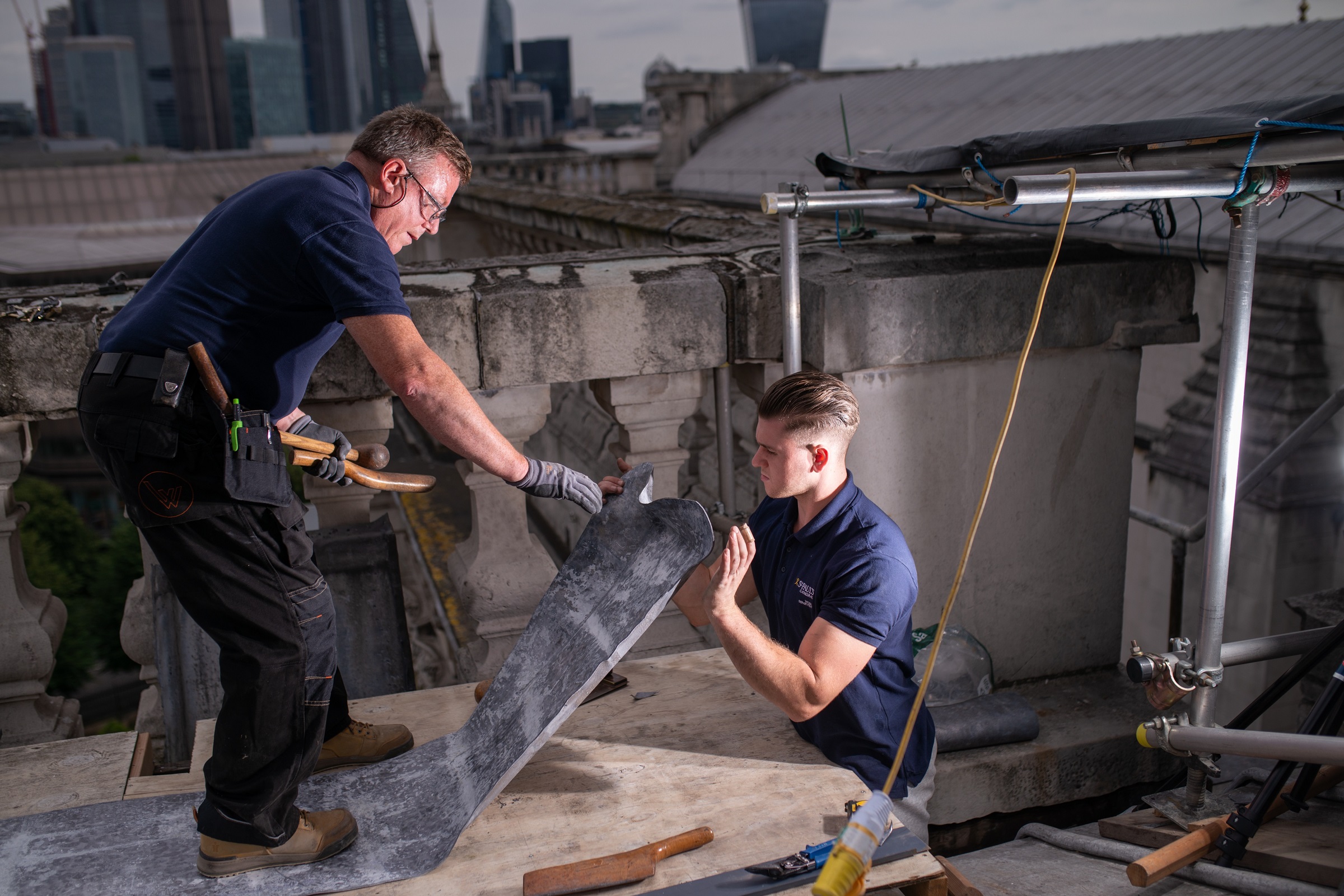 construction workers on the roof making repairs