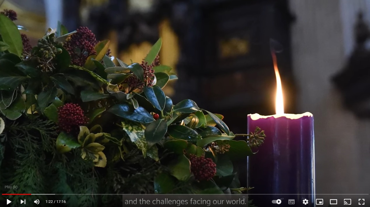 A lit purple advent candle in the wreath at St Paul's Cathedral