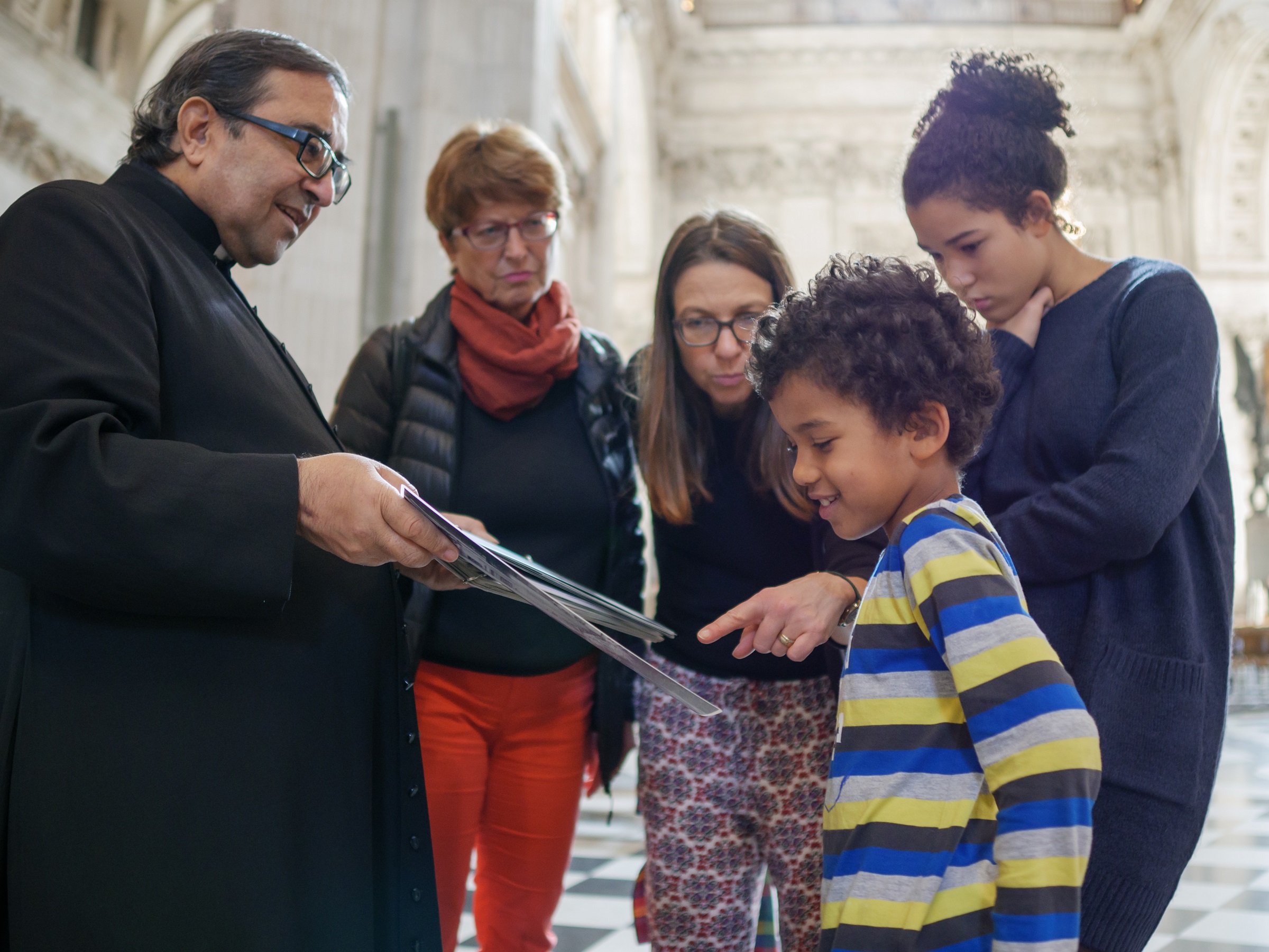 family looking at a map inside cathedral 