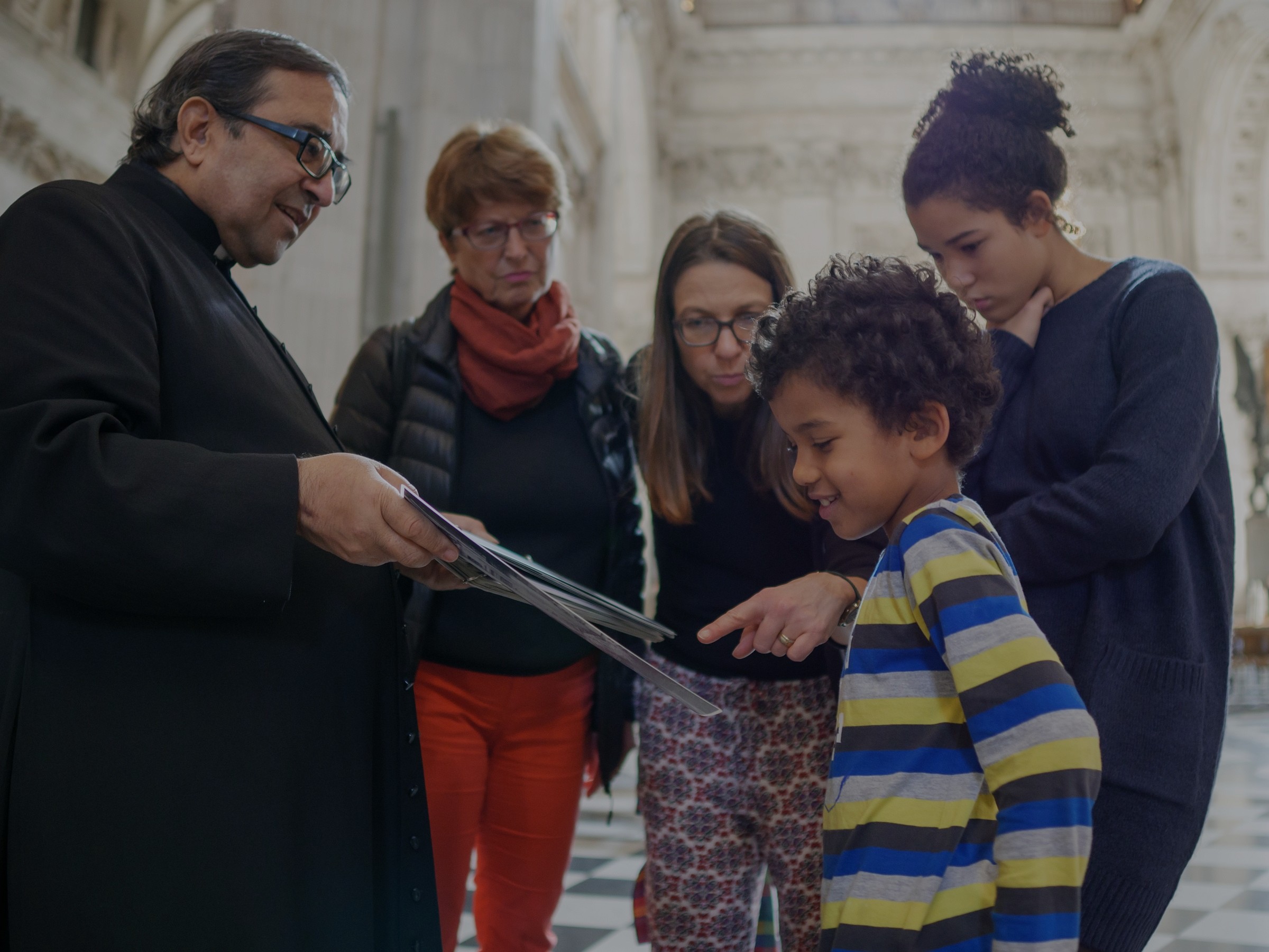 family looking at a map inside cathedral