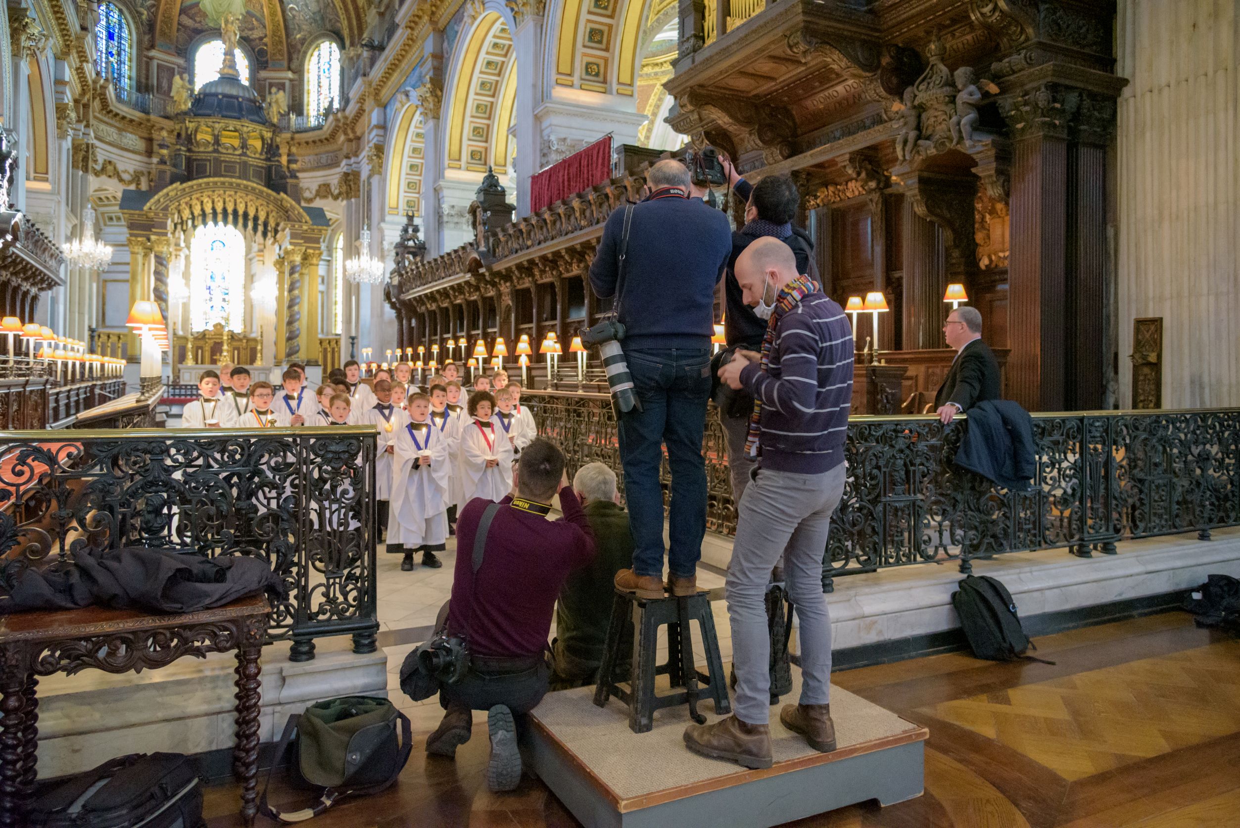 Press photographers take photos of the choristers during a media visit