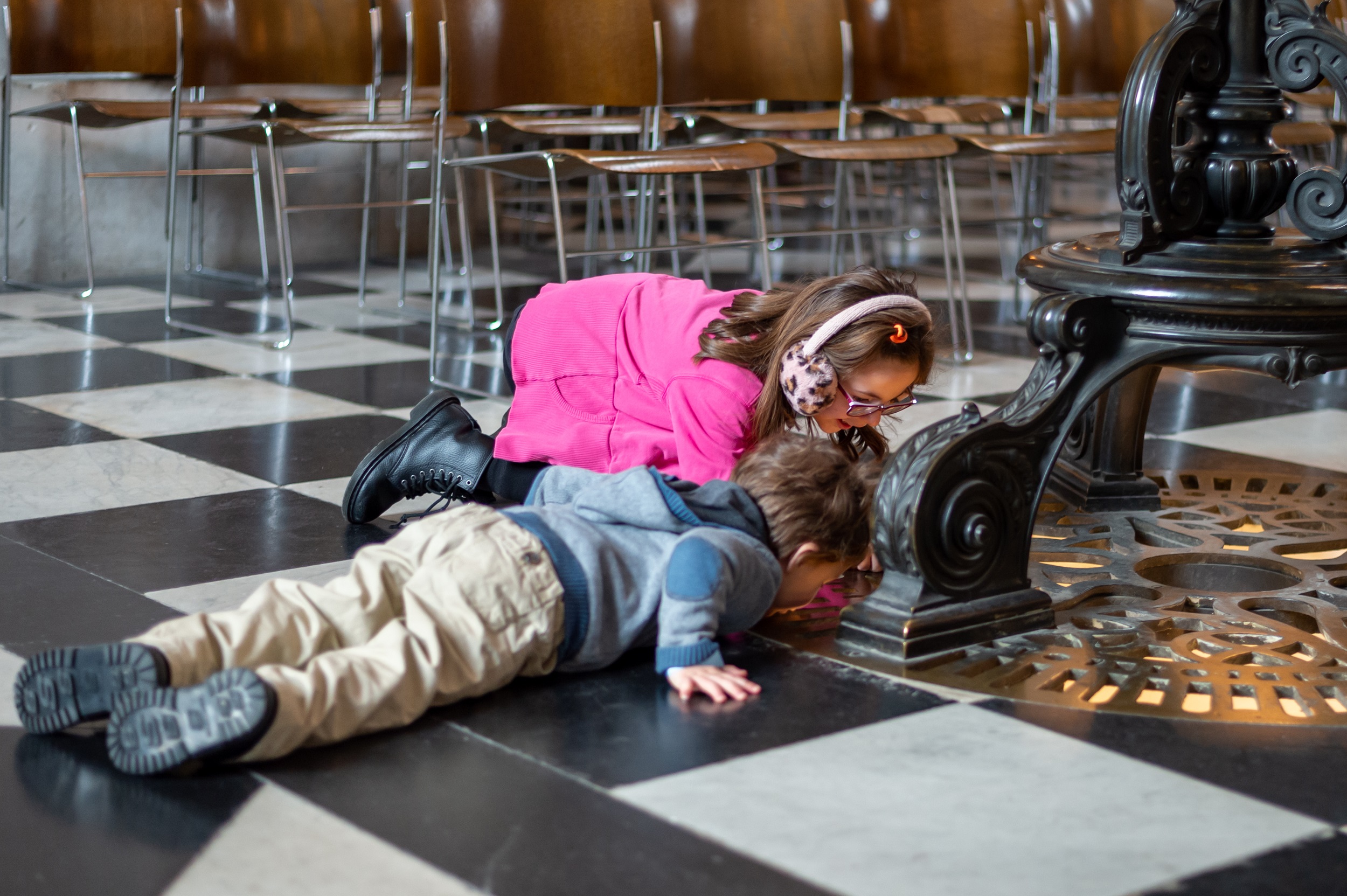 Two children look at architectural detail on the Cathedral floor