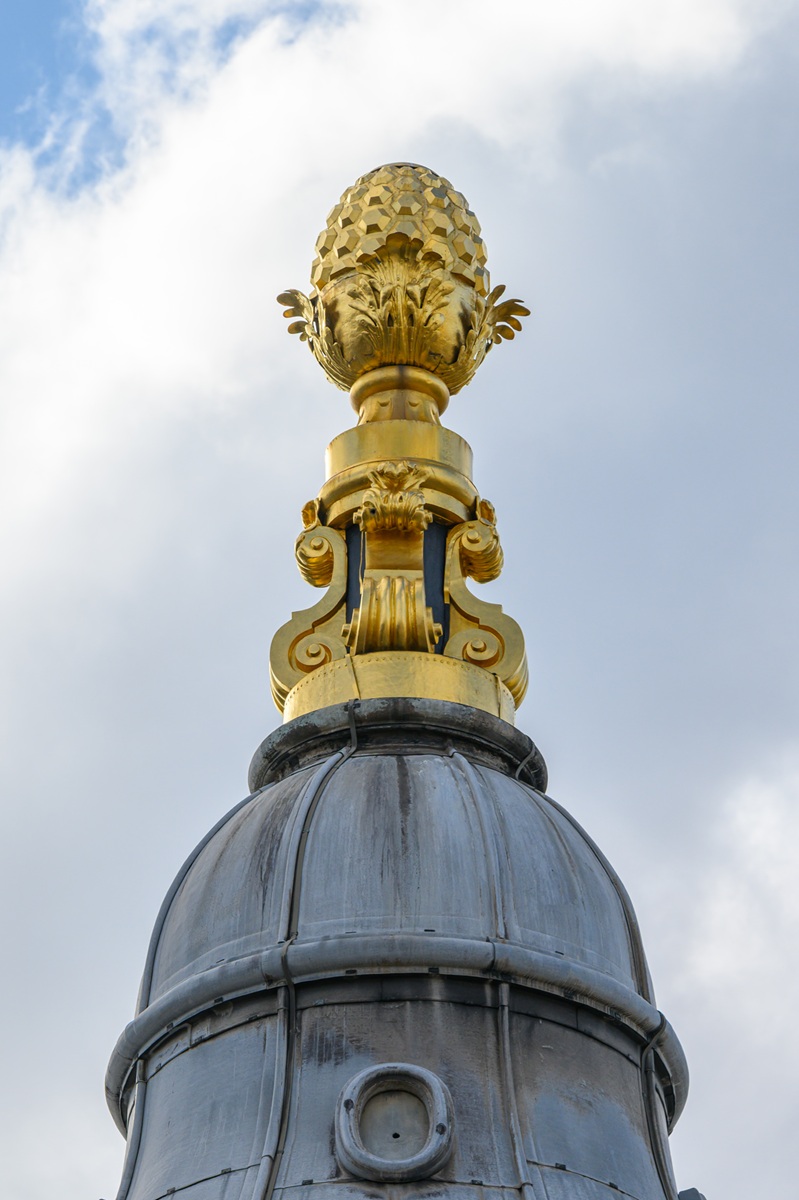 A close-up shot of a golden pineapple on top of one of the towers of St Paul's Cathedral