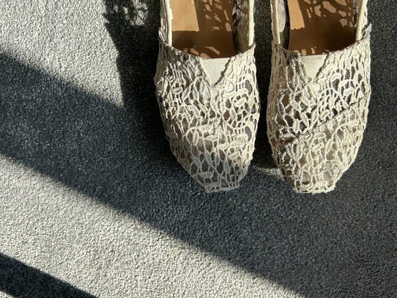 a pair of cream embroidered slippers