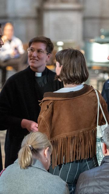 clergy priest talking to worshippers