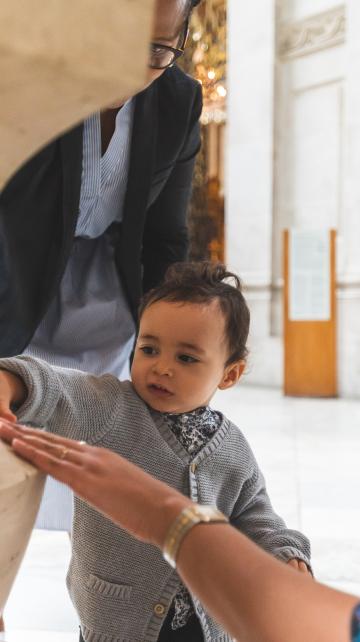 little boy touching cathedral stone
