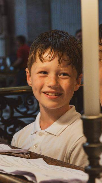 Boy smiling in the choir stalls