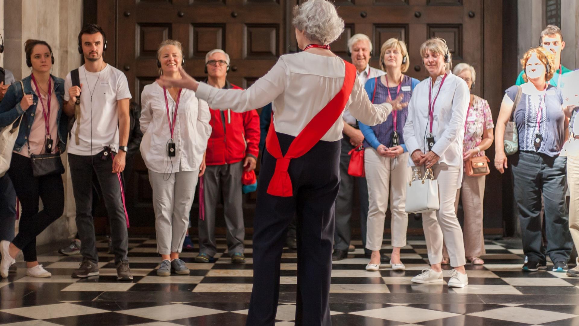 guide welcome visitors group nave entrance