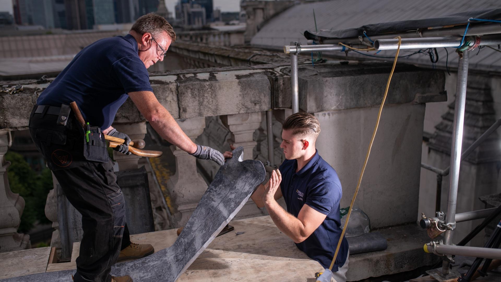 construction workers on the roof making repairs