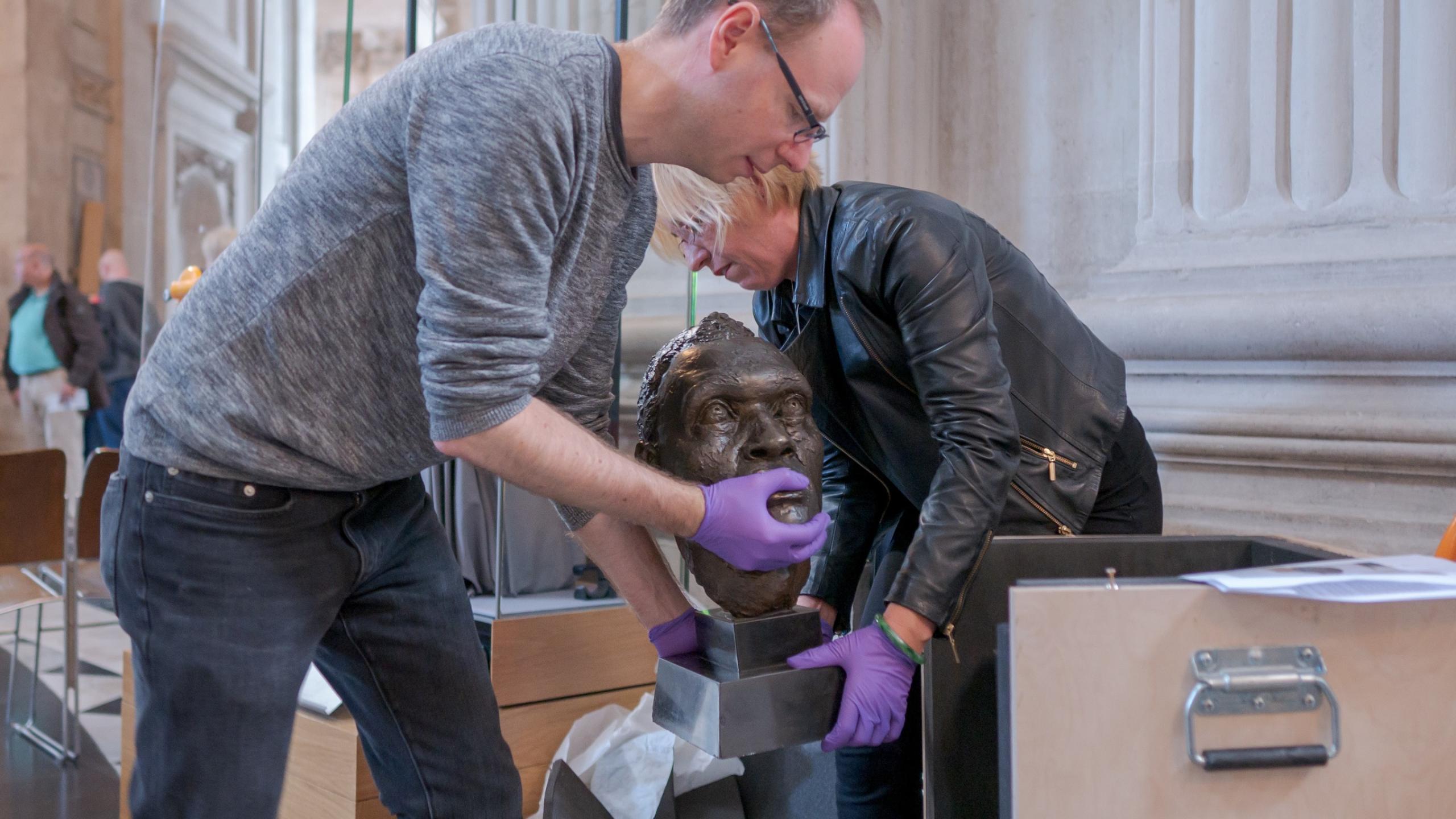 history and collections team loading bust onto plinth 