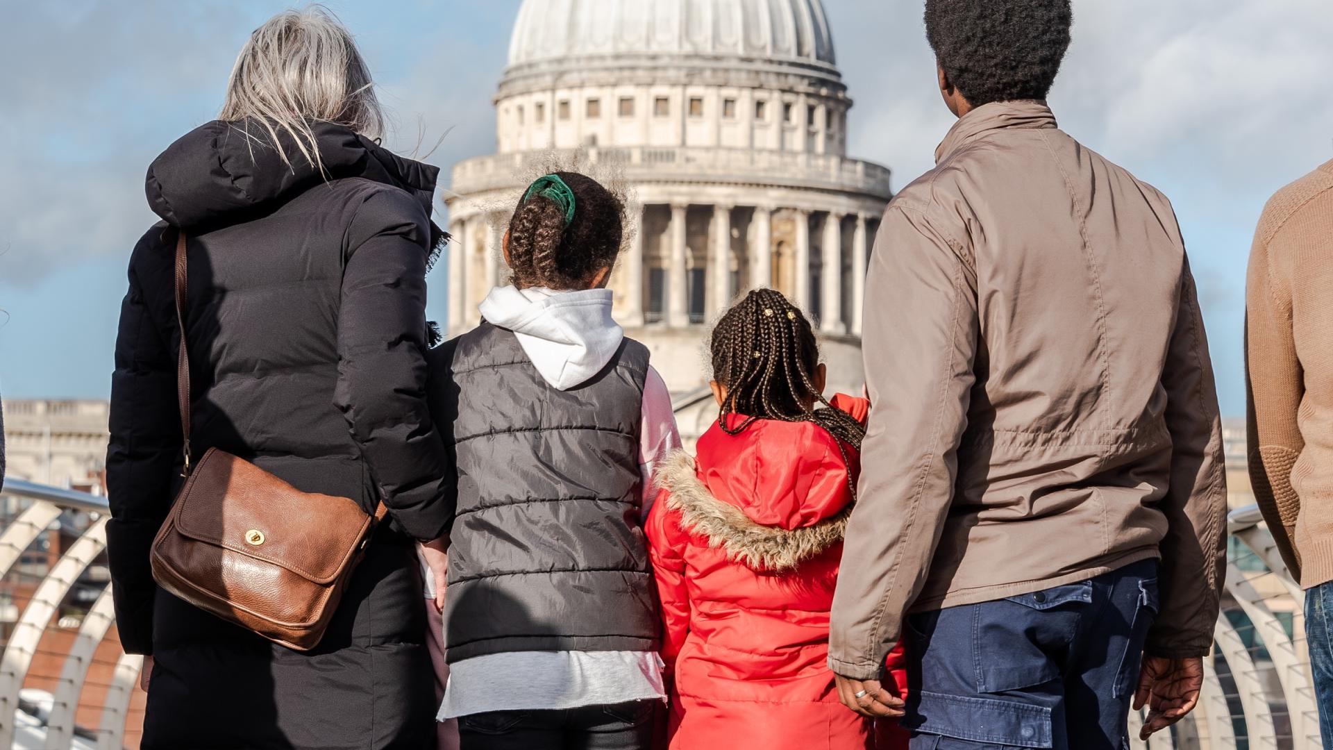 family looking at the dome from the millenium bridge