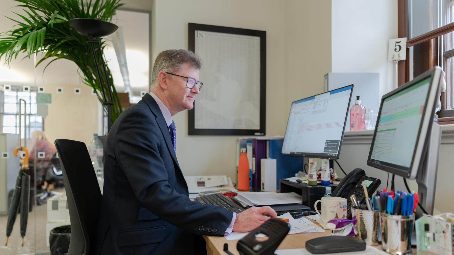 member of staff working at desk 