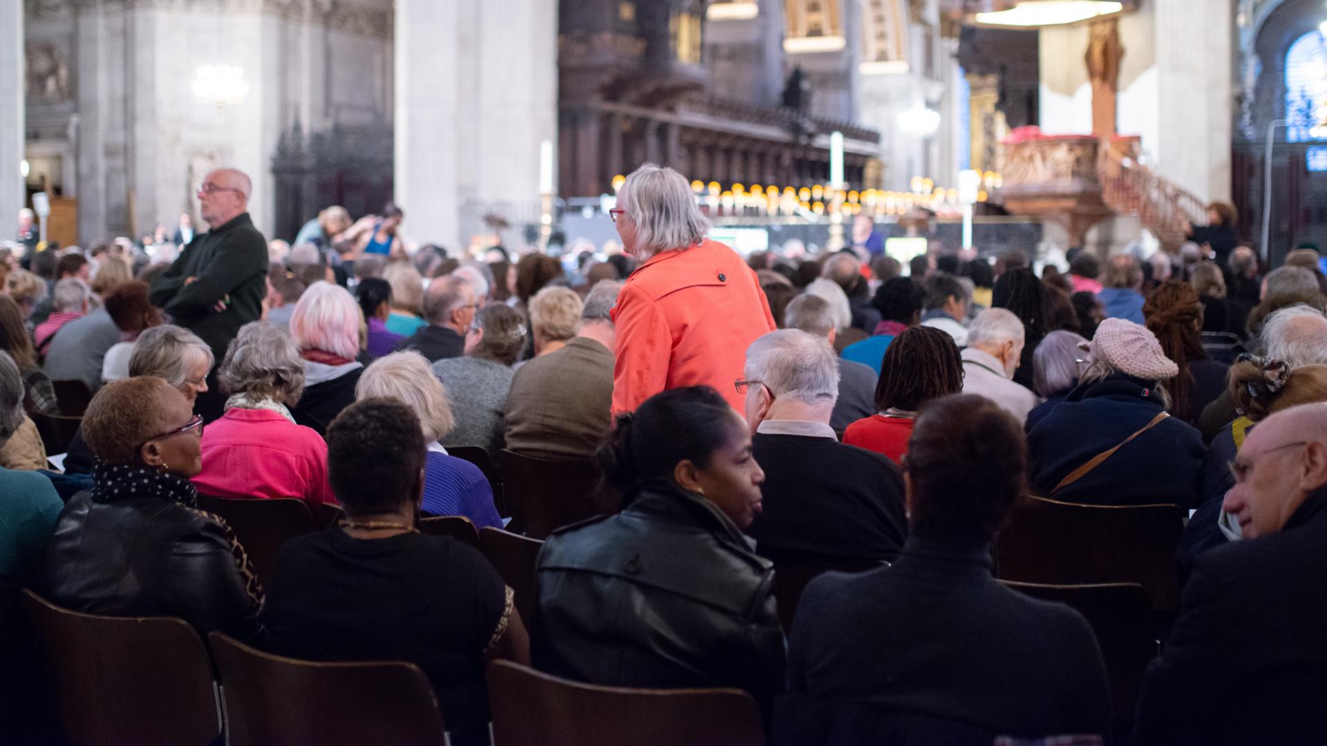 Audience members take their seats at an event at the cathedral