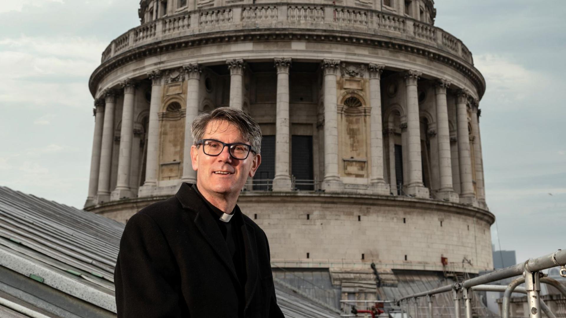 Dean of St Paul's, Andrew Tremlett sits in front of the Dome of the Cathedral