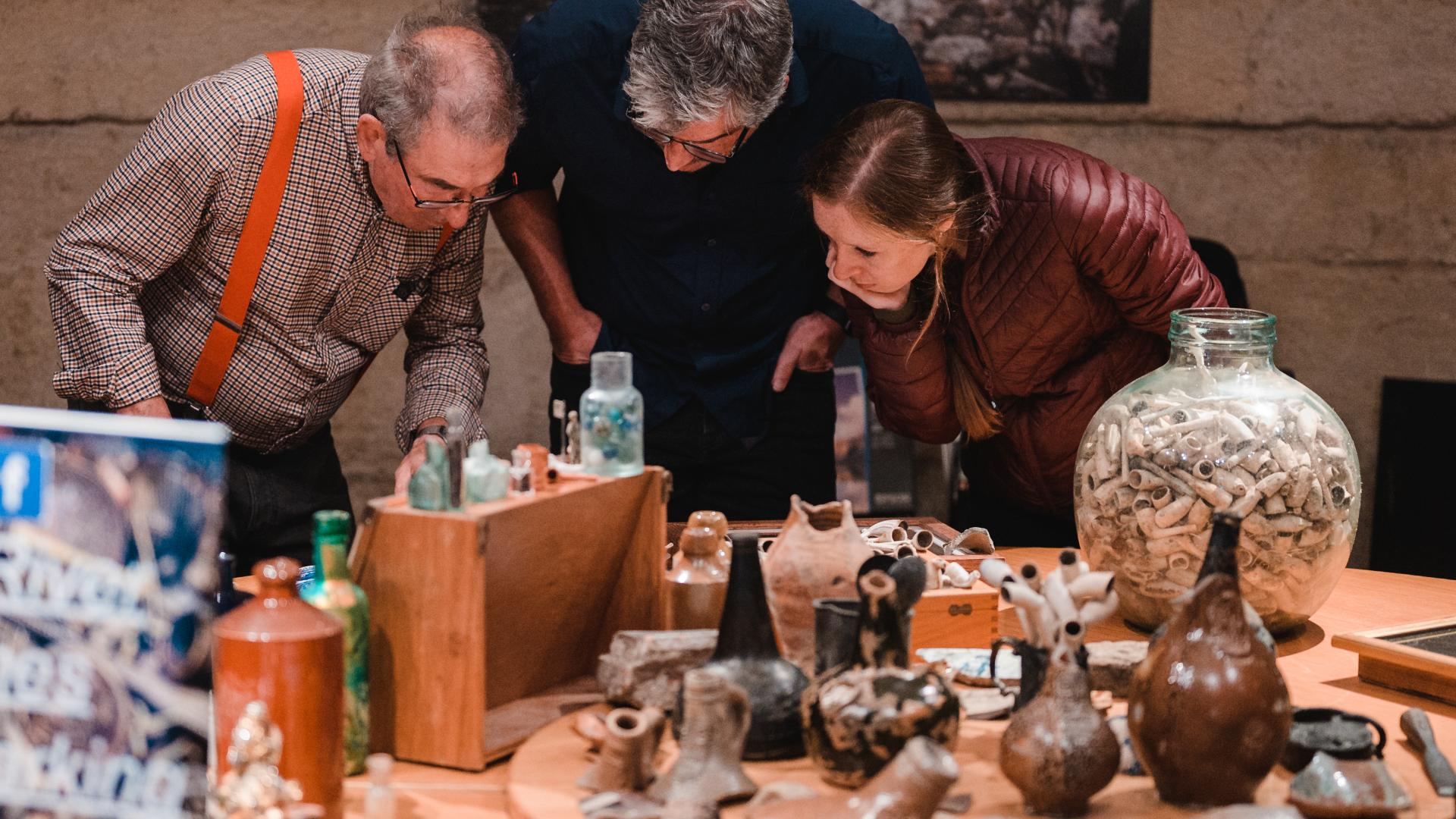 People looking at mudlarking finds.