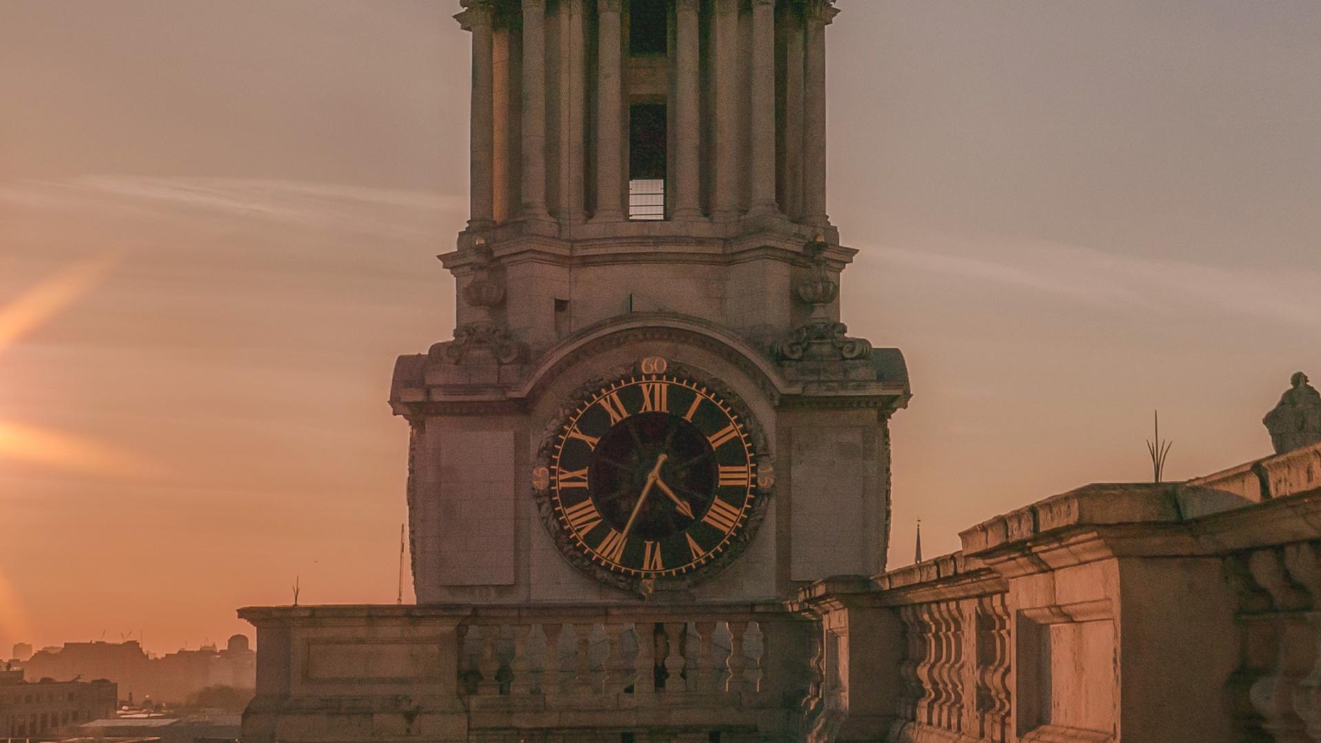 The clock tower seen from the roof looking towards the west, at sunset with the glow of the setting sun to the side