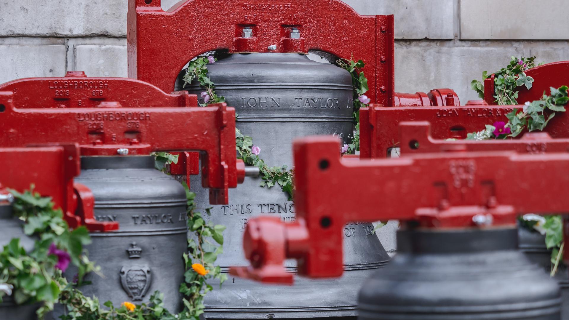 The bells, decorated with flower garlands and with newly painted red yokes, sit outside the cathedral to be blessed before being re-hung after refurbishment.