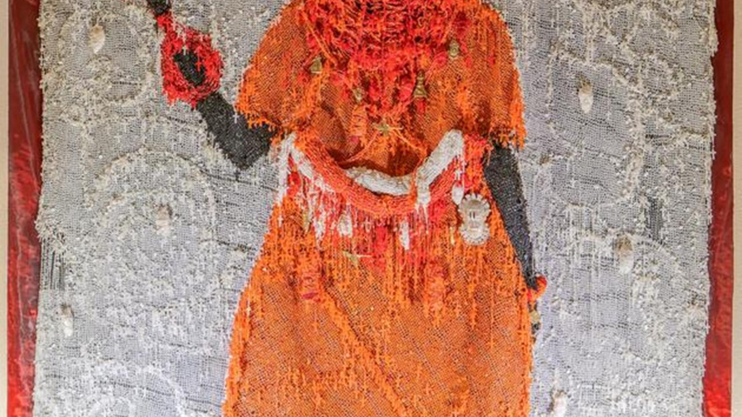 The artwork Still Standing is a mixed media installation, combining rosary beads and Benin bronze hip ornament masks to depict an Oba (King) of Benin. 