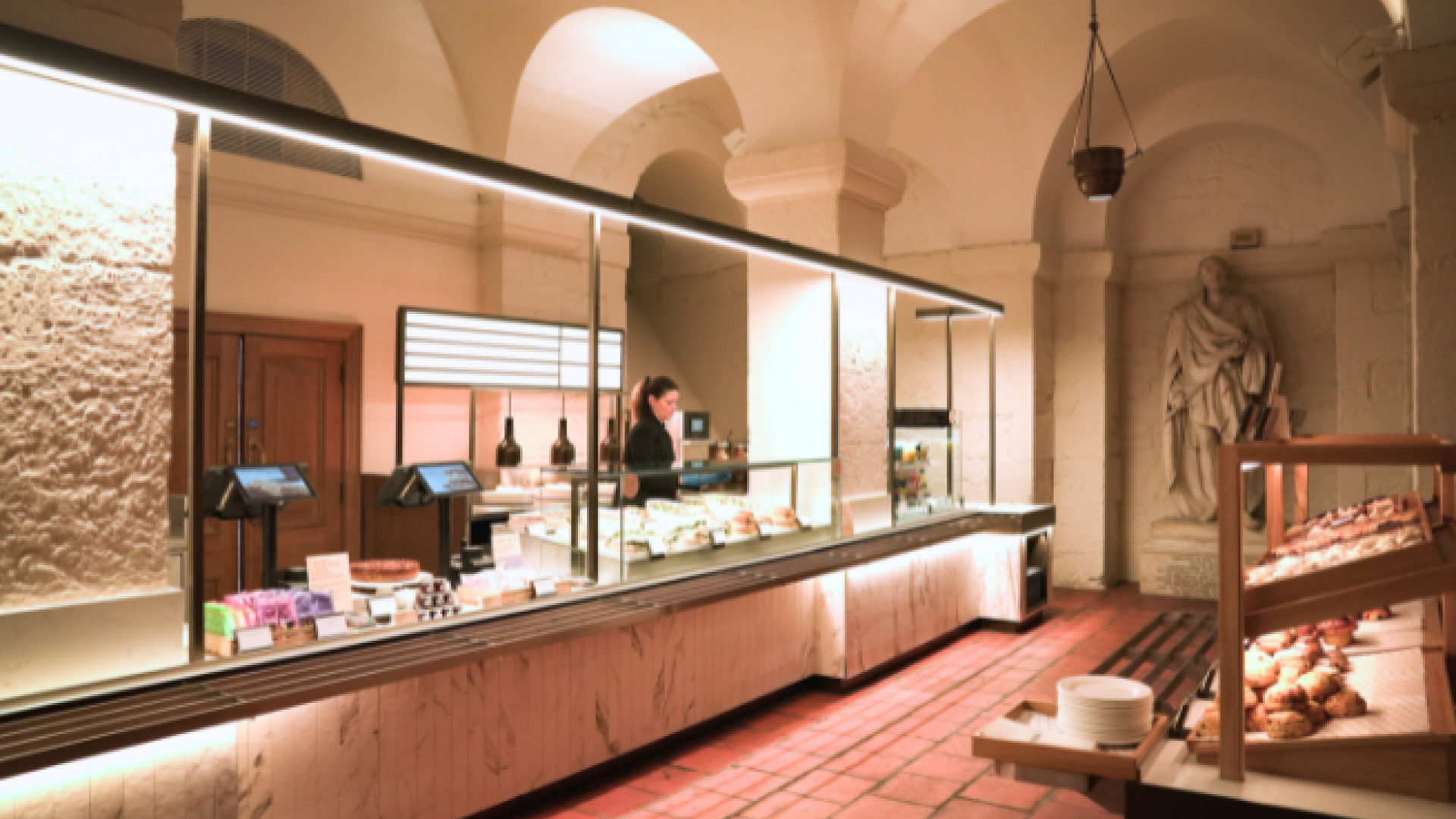 A wide shot of the new Crypt Cafe, with arched ceilings and a long countertop.