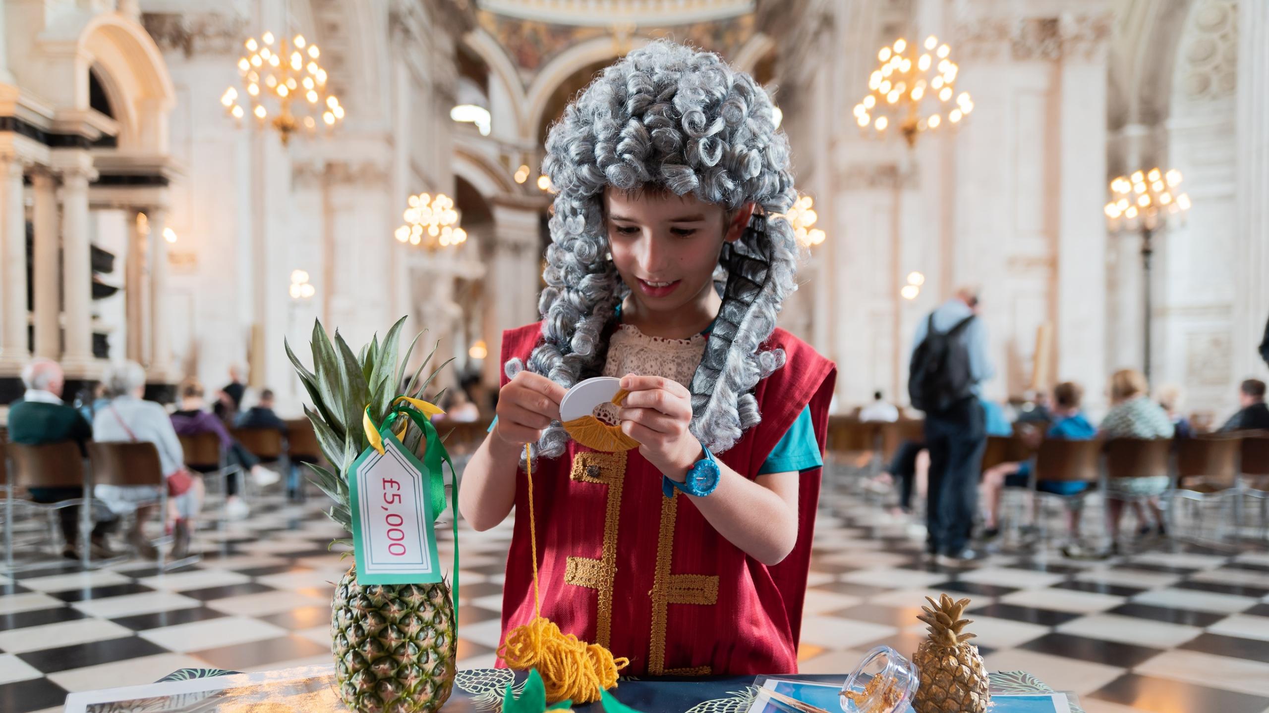 child dressed as Christopher Wren doing craft activities