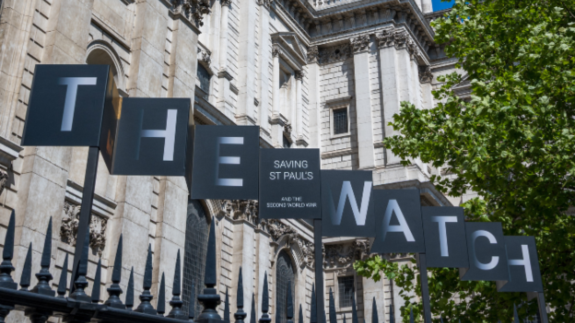 The sign for the exhibition; large letters which spell THE WATCH with 'Saving St Paul's' and 'And the Second World War' in smaller lettering between the two words.