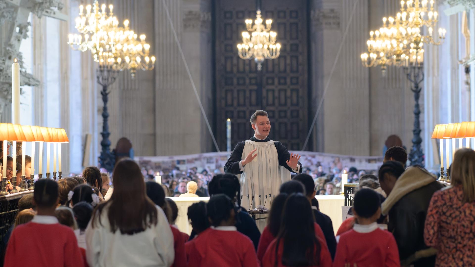 Conductor leading choir of children