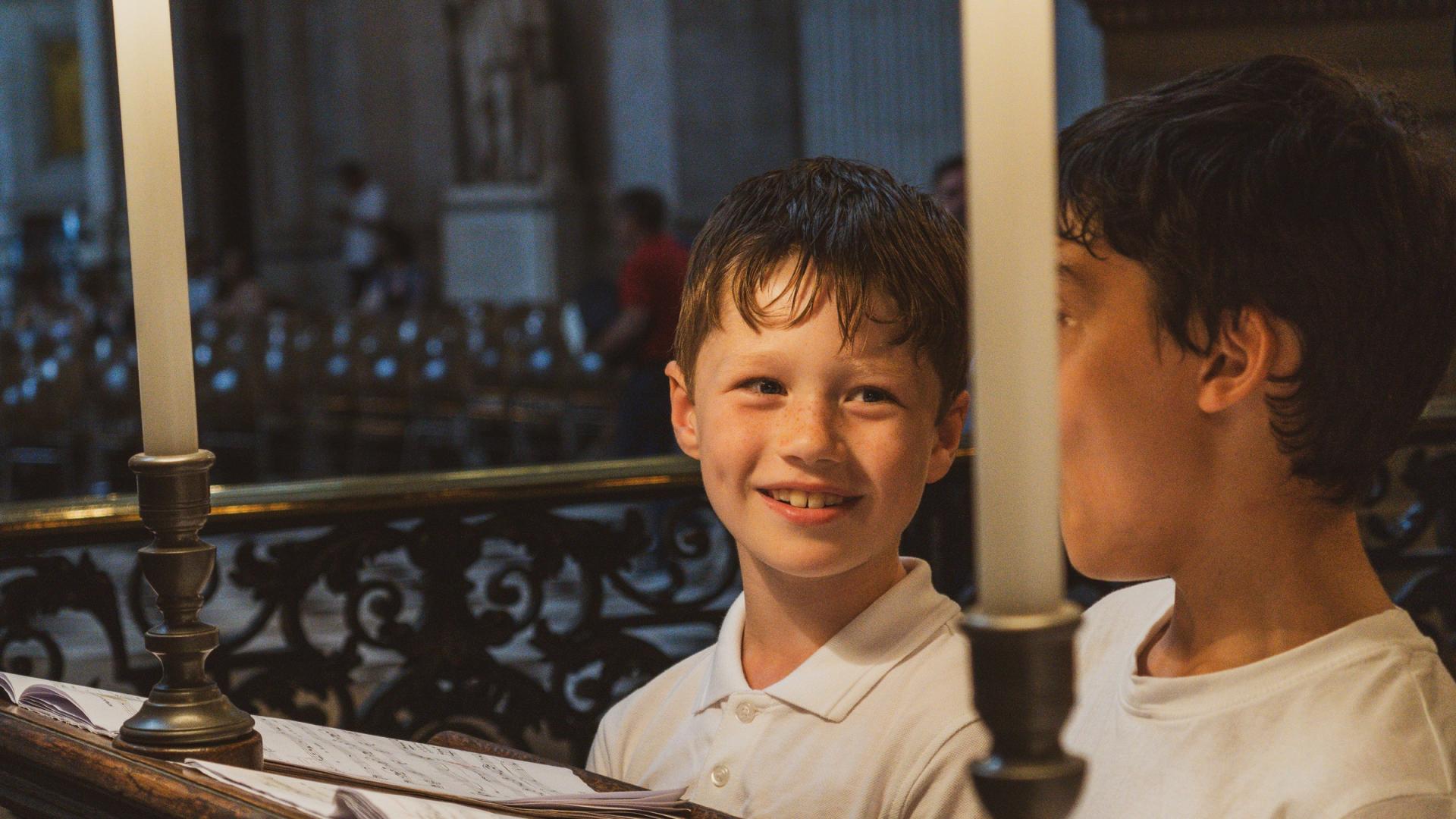 Boy smiling in the choir stalls
