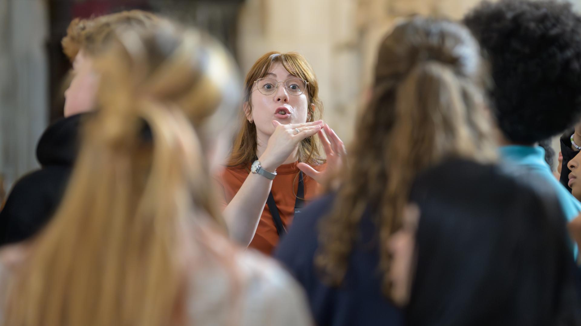 Emma, a member of the Learning team, speaks to visitors on a tour.