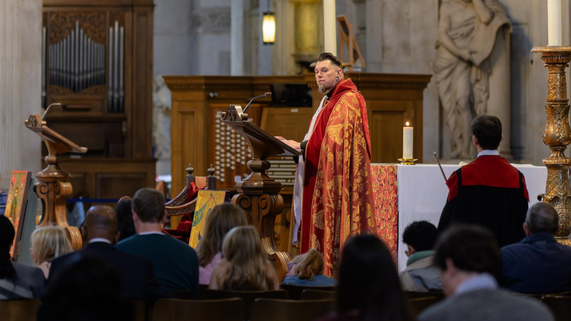 The Revd Timothy Miller speaks from a lectern.