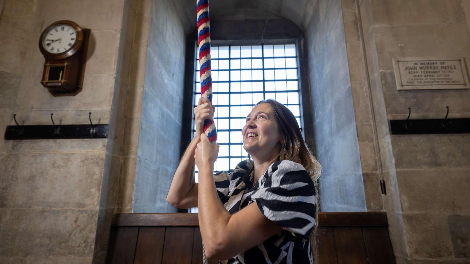 A bereaved mother rings a bell at St Paul's Cathedral in memory of her late daughter