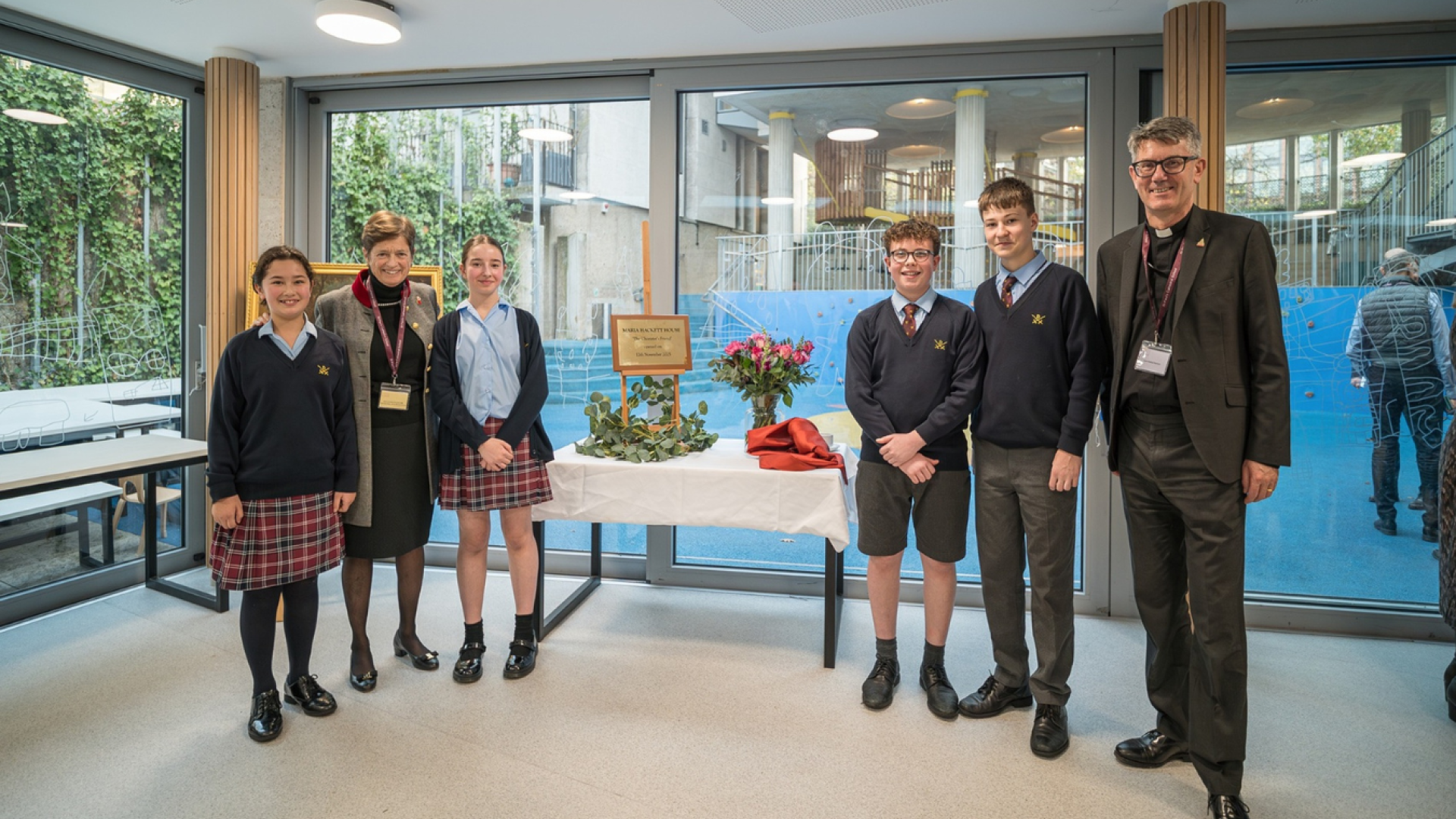 Four choristers stand with the Dean and the Head of St Paul's Cathedral School at the opening of the new girls' boarding house.
