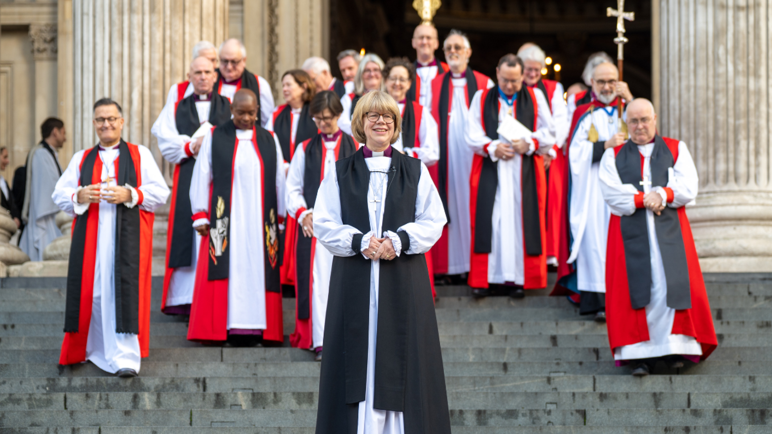 Archbishop Sarah stands ahead of a group of bishops on the West Steps.