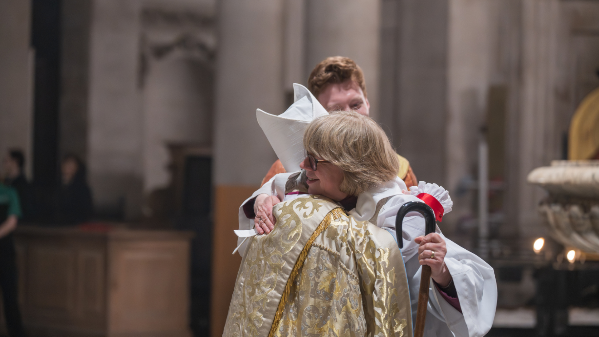 Bishop Sarah hugs a member of the clergy