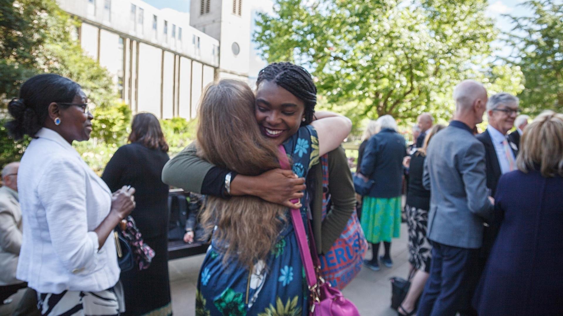 Two women hugging and smiling