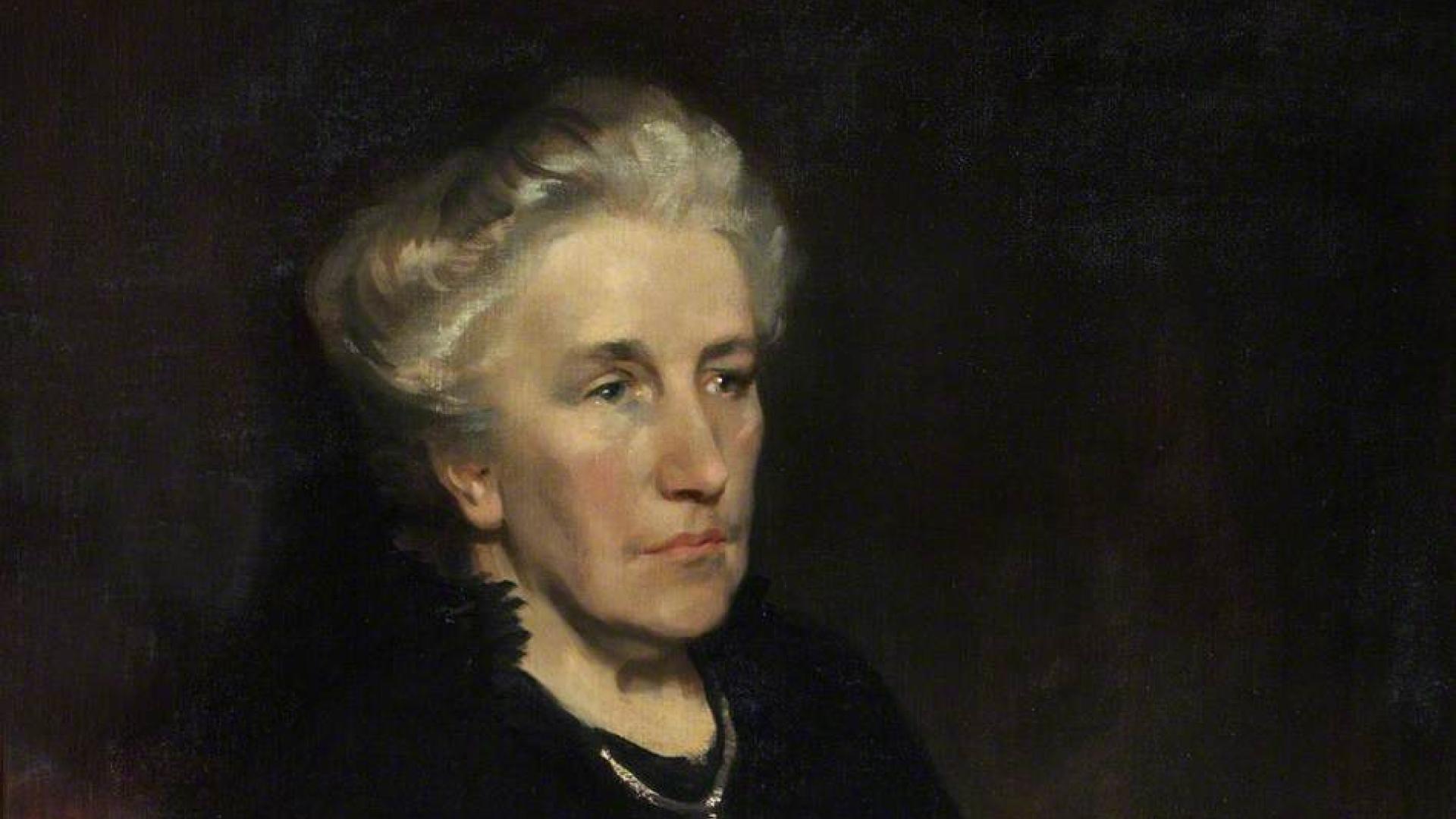 A painting of Louise Creighton, activist. Louise is depicted in later life, seated with her hands folded in her lap. She wears a plain black dress and large silver cross on a chain. Her grey hair is worn in a bun.