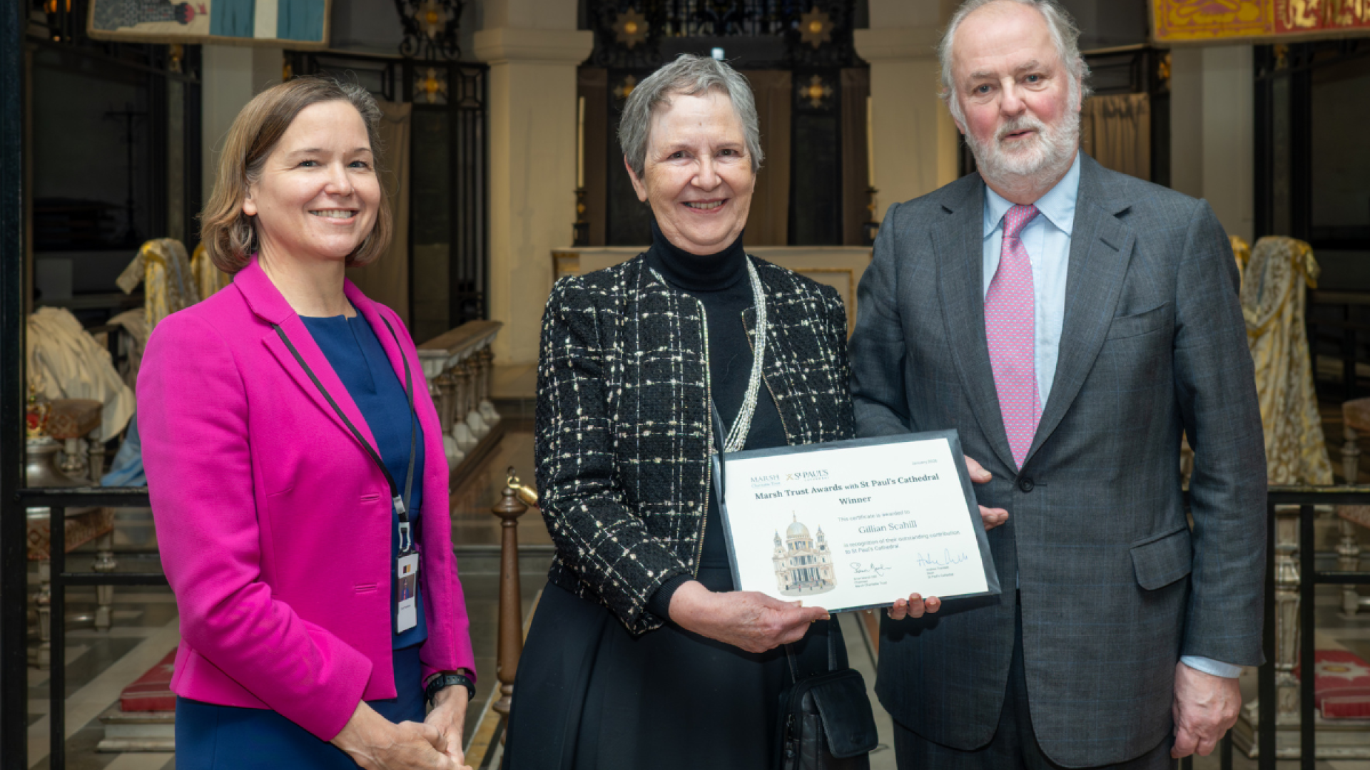 Gillian, a volunteer, holds her certificate.