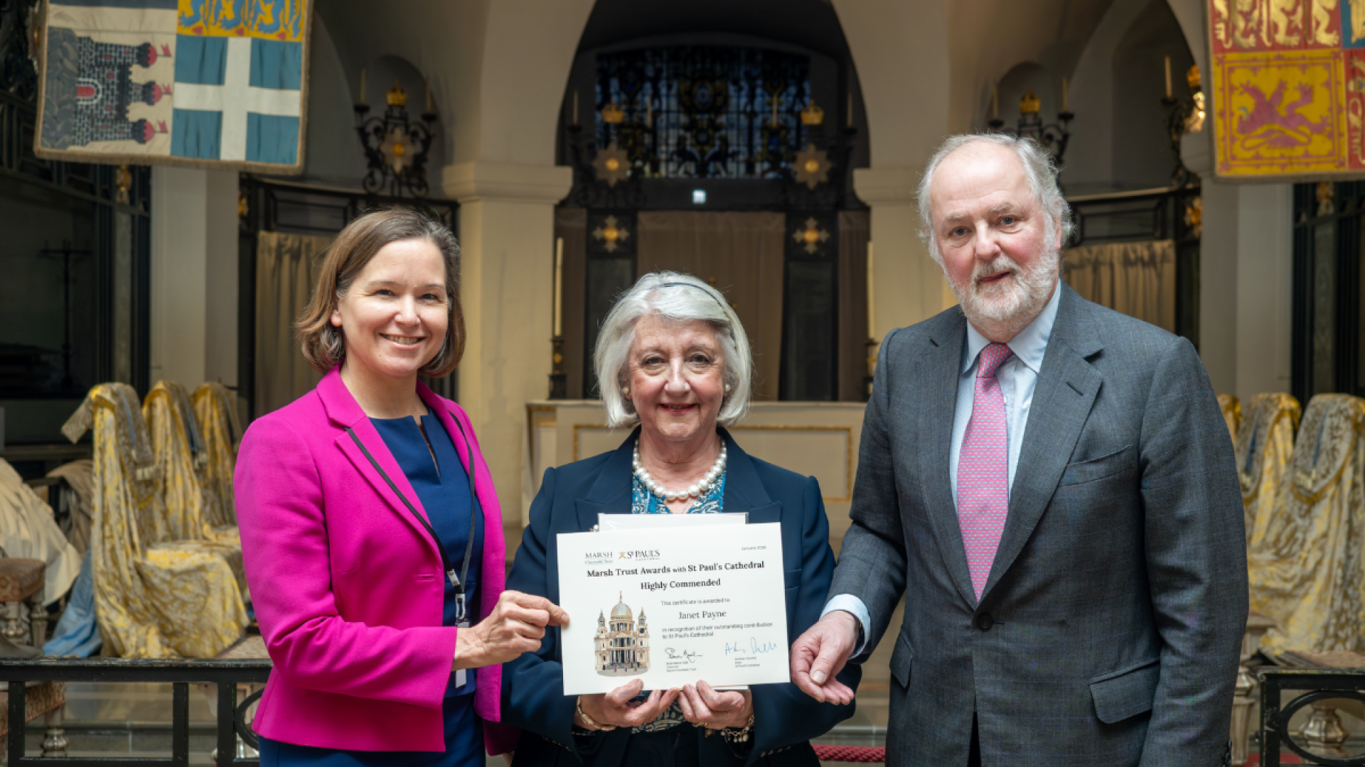 Janet, a volunteer, holds her certificate.