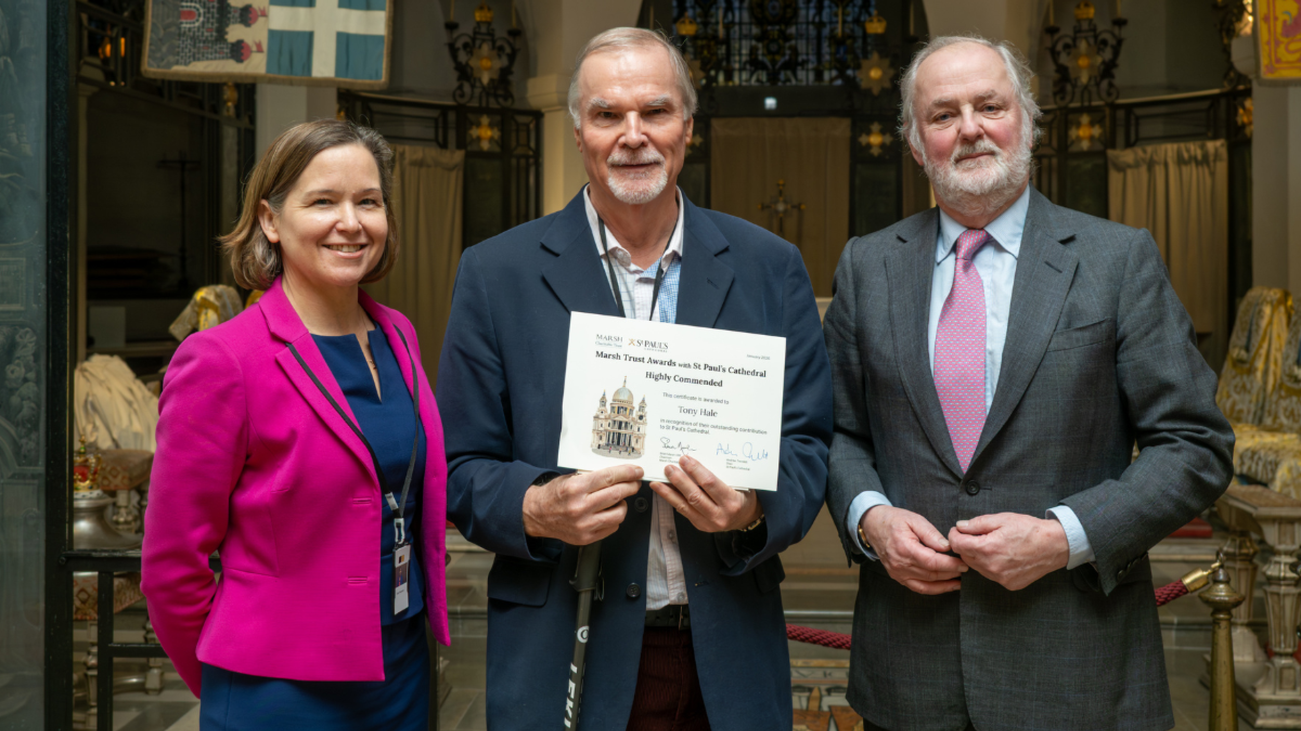 Tony, a volunteer, holds his certificate.
