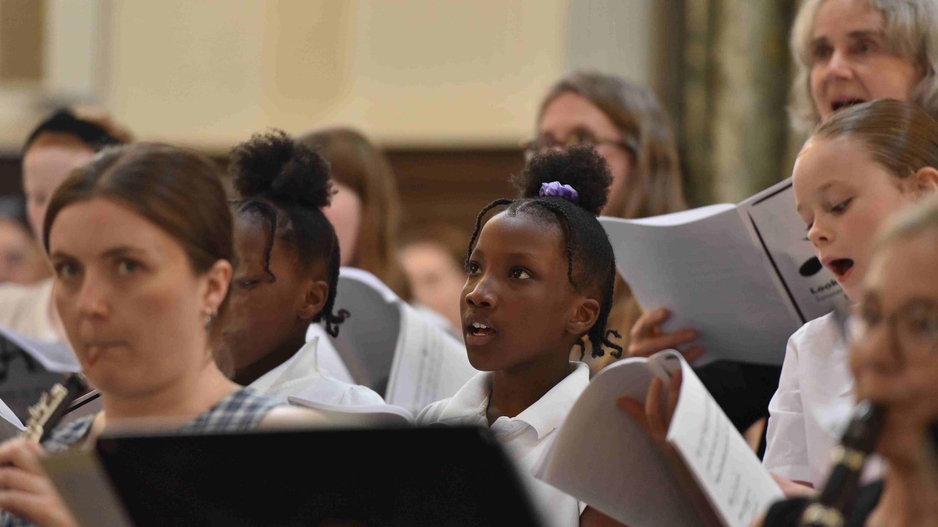 Children and musicians perform at a concert