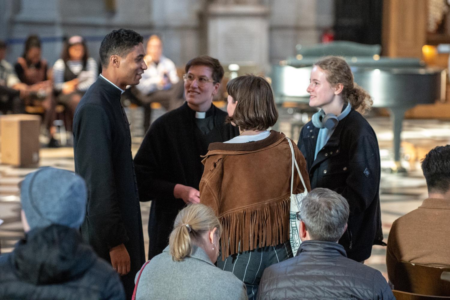 clergy priest talking to worshippers