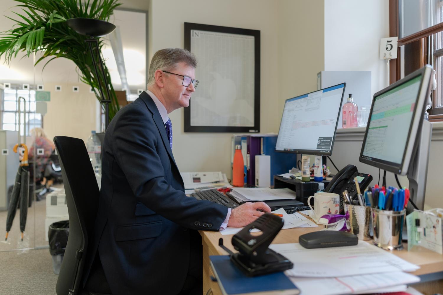 member of staff working at desk 