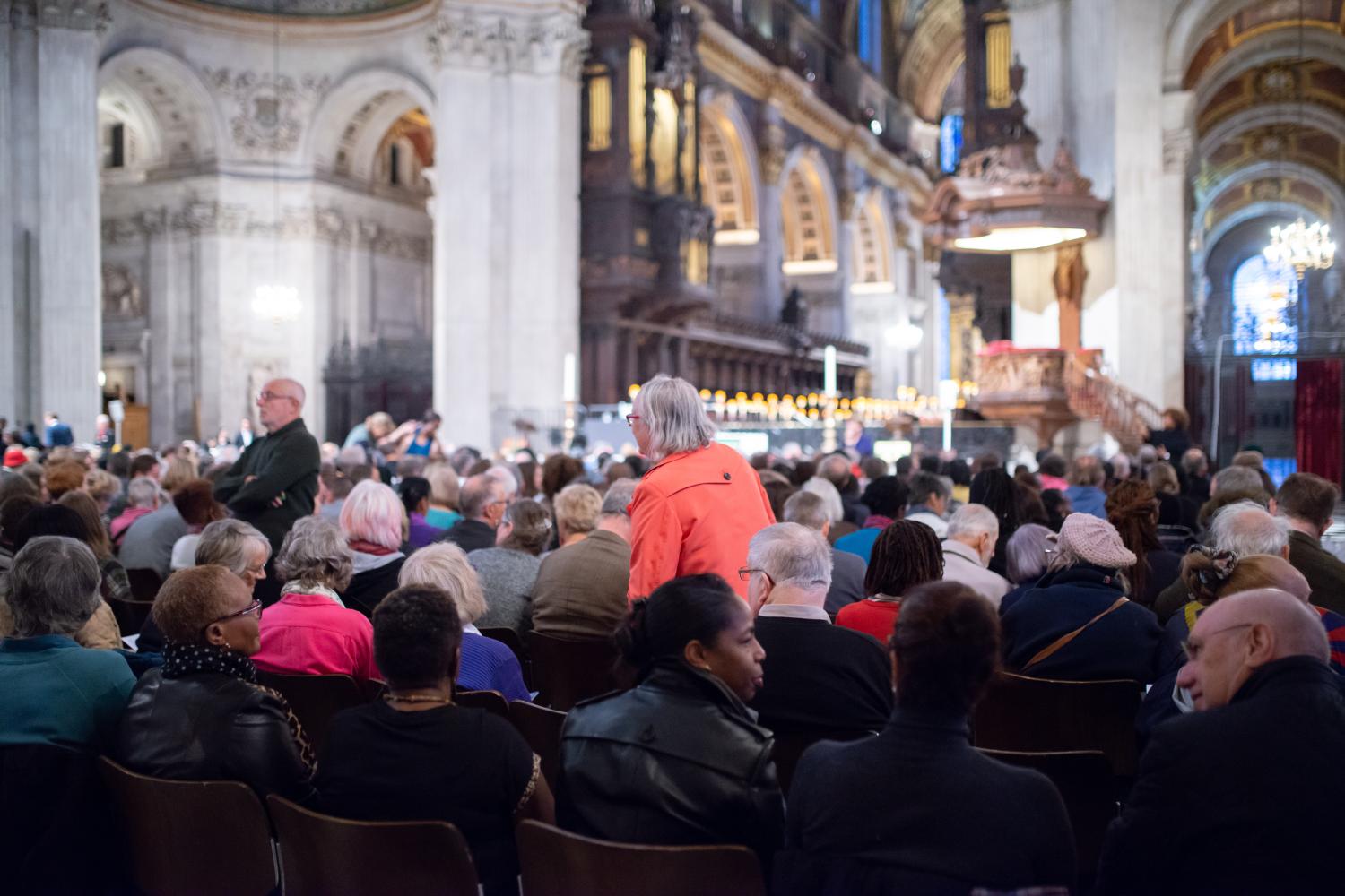 Audience members take their seats at an event at the cathedral