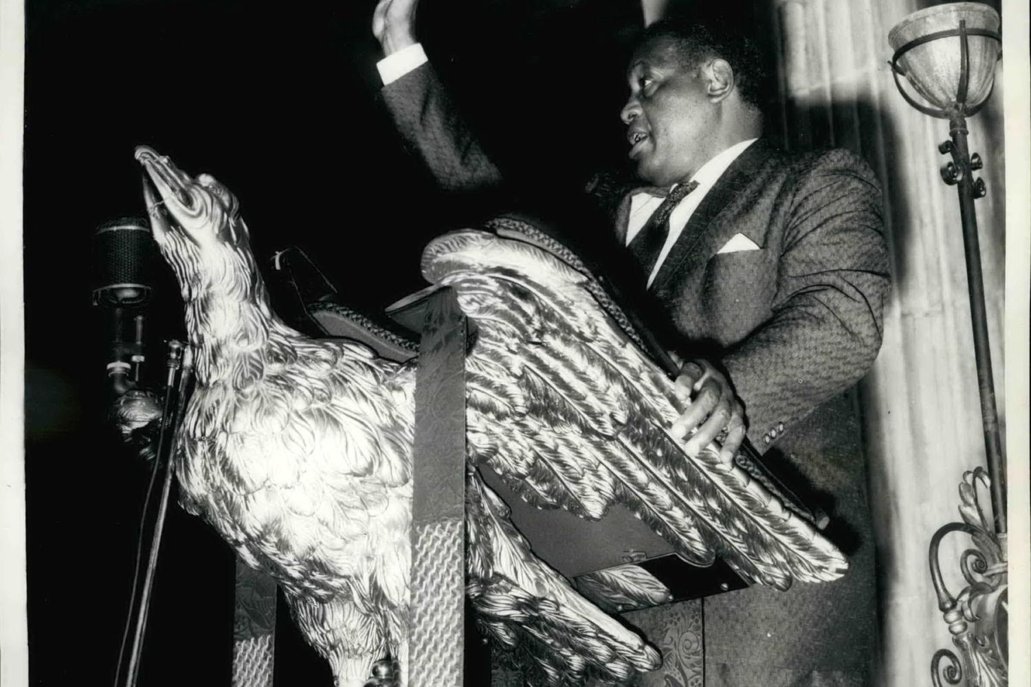 Paul Robeson standing at the eagle lectern, 10 October 1958