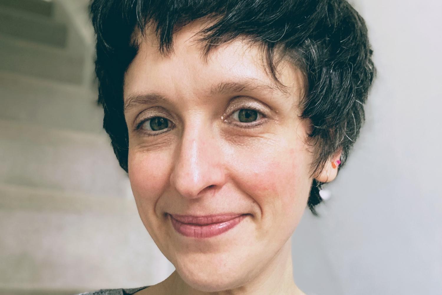 A smiling short-haired woman