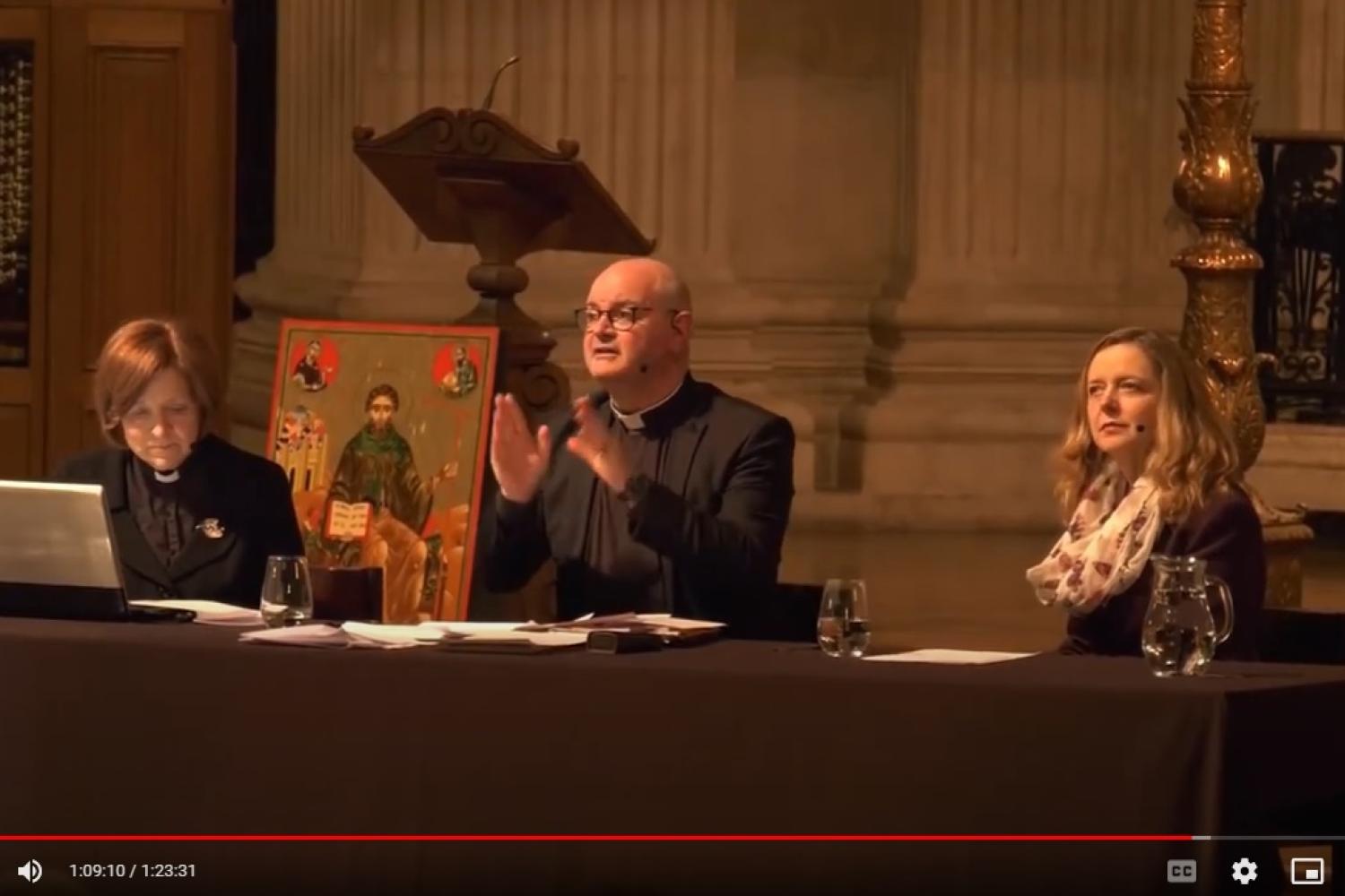Mark Oakley and Paula Gooder speaking from a table on the dais at St Paul's.