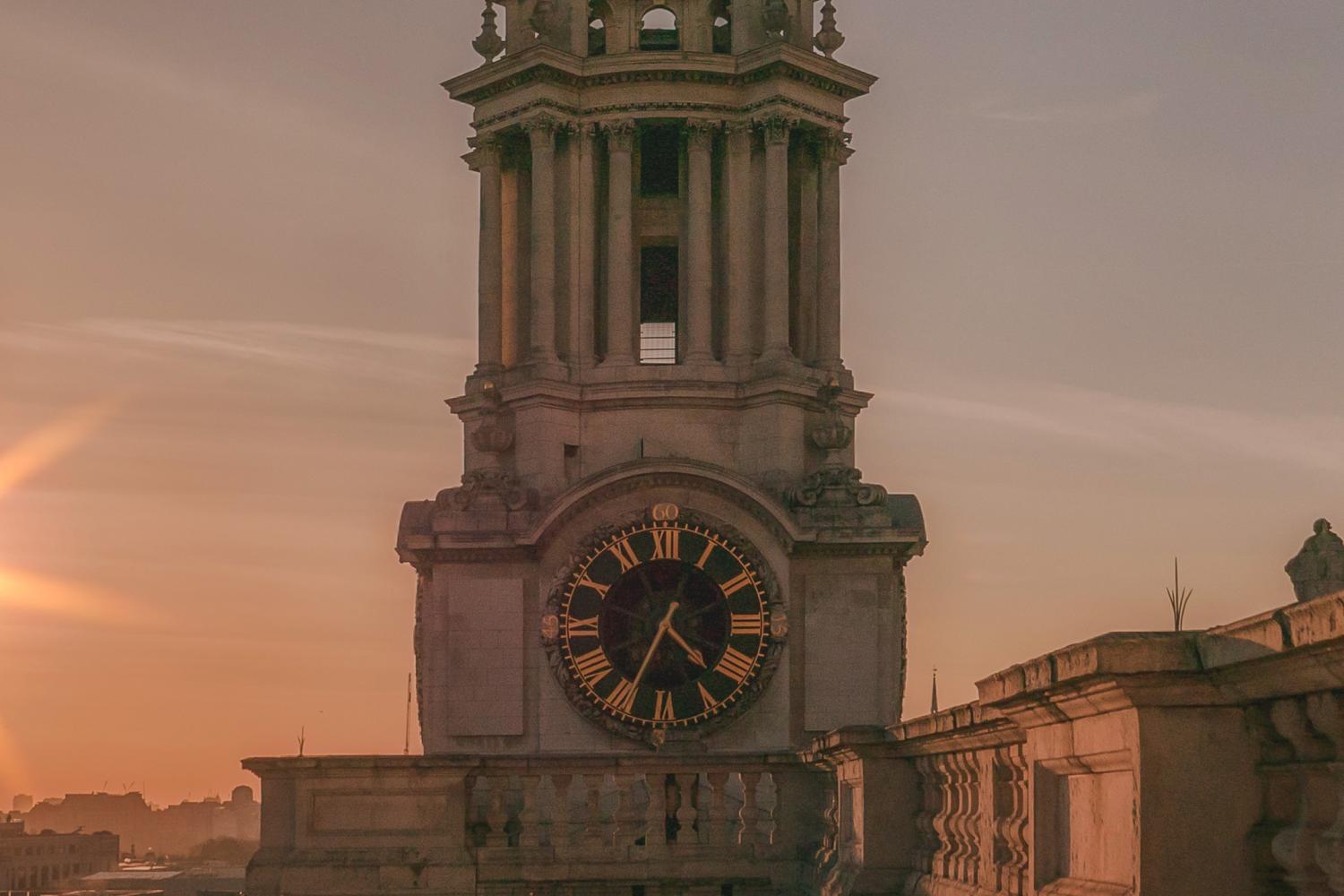 The clock tower seen from the roof looking towards the west, at sunset with the glow of the setting sun to the side