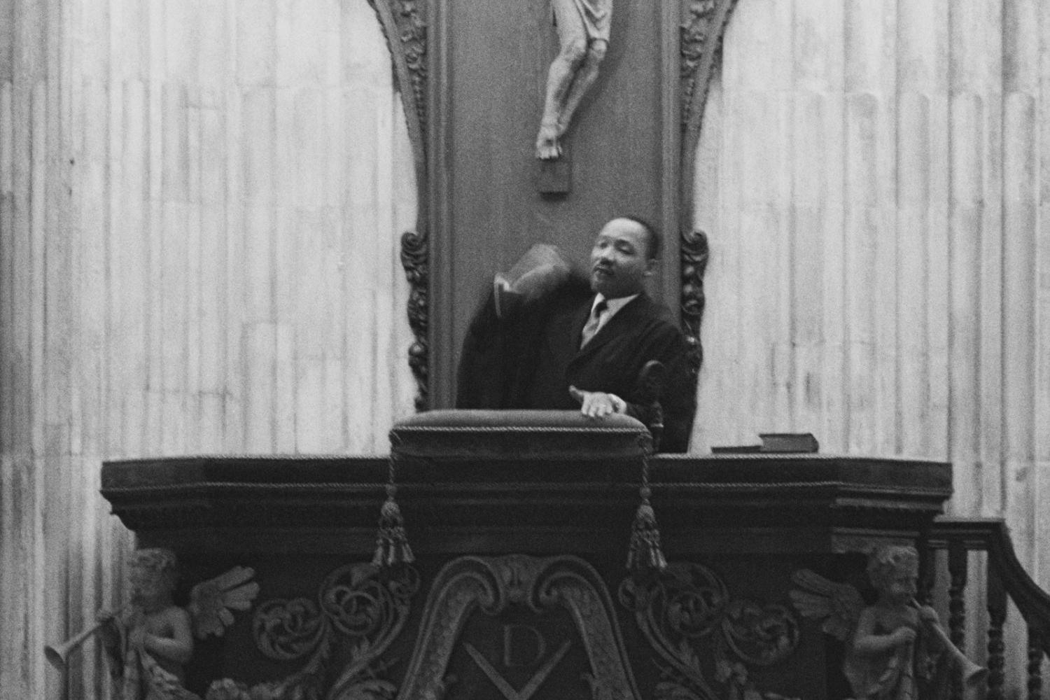 A black and white image of Martin Luther King standing in the pulpit at St Paul's