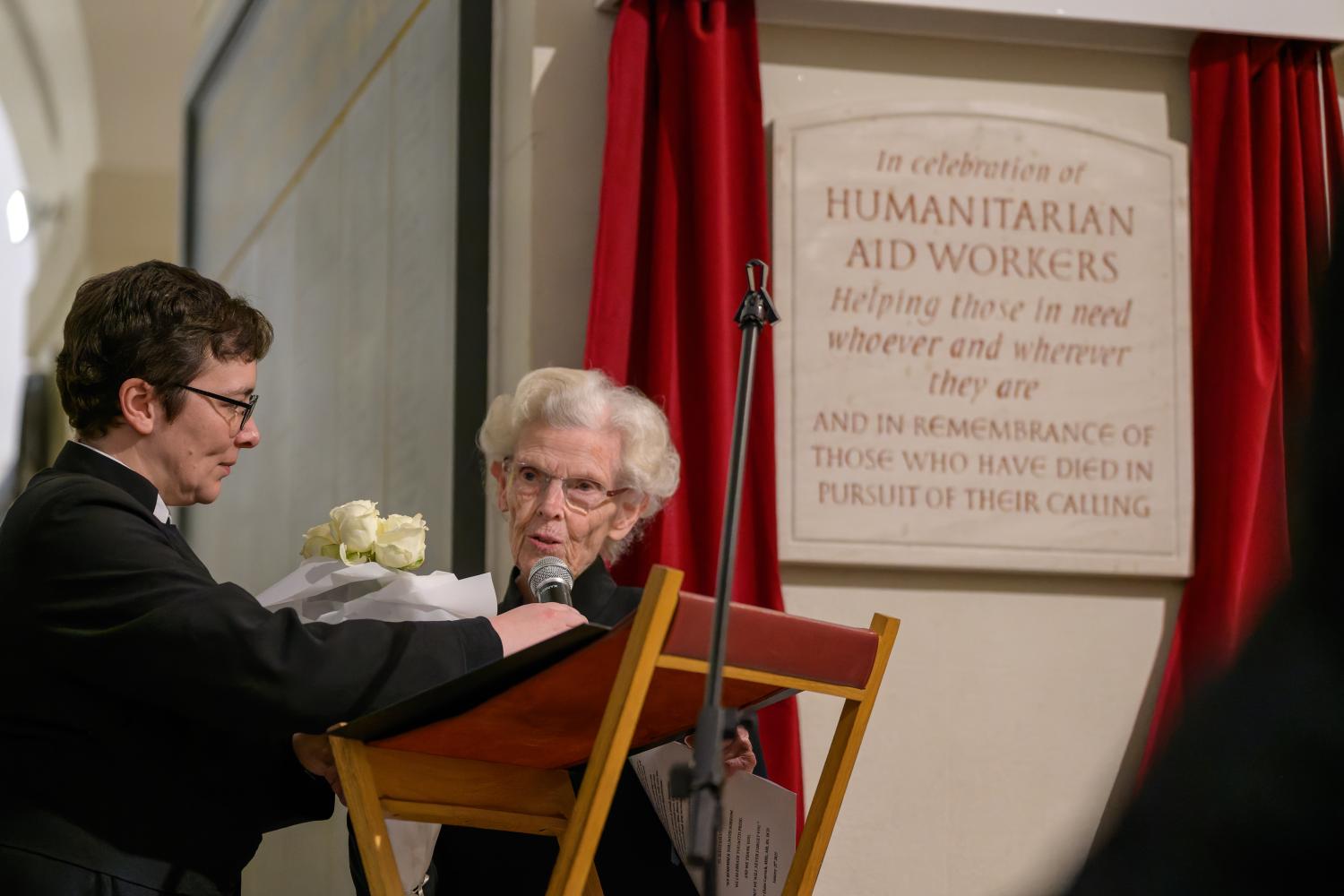 A photo of a new plaque being unveiled in the Crypt of St Paul's Cathedral, with two women standing in front.