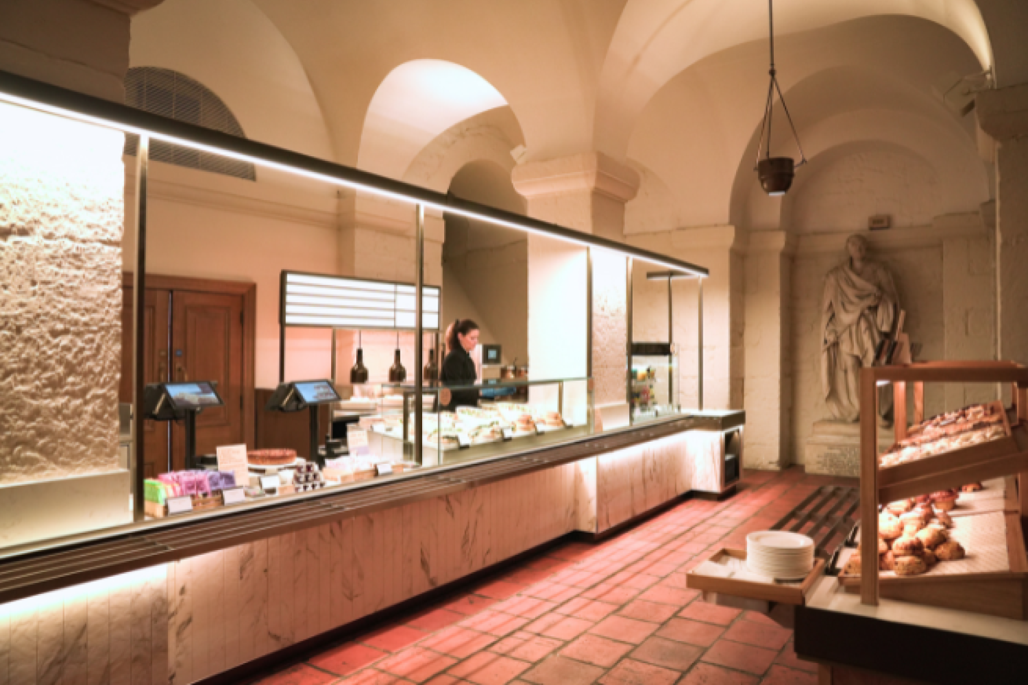A wide shot of the new Crypt Cafe, with arched ceilings and a long countertop.